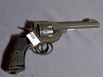a gun that is on a table with a price tag on it