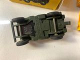 a green toy truck with a metal buckle on it