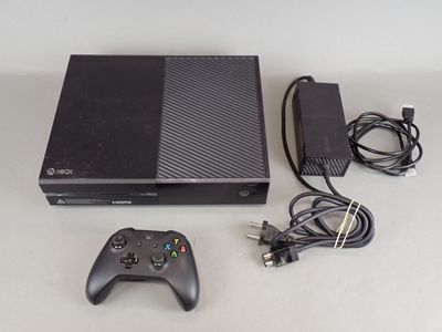 a video game console and a game controller on a table