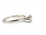 a close up of a diamond ring on a white background