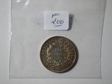 a small coin in a clear bag with a tag on it