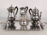 a silver tray with a silver tea set on it