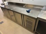 a stainless steel sink in the middle of a kitchen