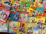 a lot of mickey mouse books on the table