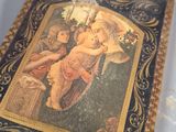 a small box with a painting on it on a table