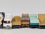 a lot of toy cars that are lined up on the table
