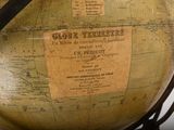 a close up of a large globe with a black handle
