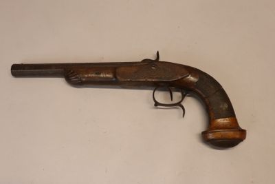 gros plan d'un pistolet sur une table à fond blanc