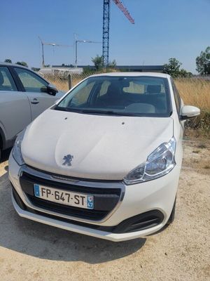 two cars parked next to each other on a dirt road