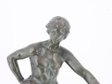 a bronze statue of a man holding a basketball ball