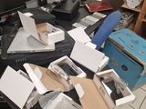 a pile of computer equipment on a desk with a computer monitor