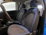 the interior of a car with a blue seat cover and a black steering wheel
