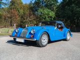 an image of a blue sports car parked in a parking lot