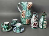 many different types of vases and cups on the table