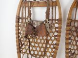 two snowshoes hanging on the wall next to each other