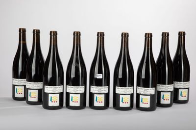 six bottles of wine lined up in a row on a table