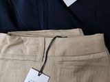 three men ' s pants with tags on them sitting next to each other