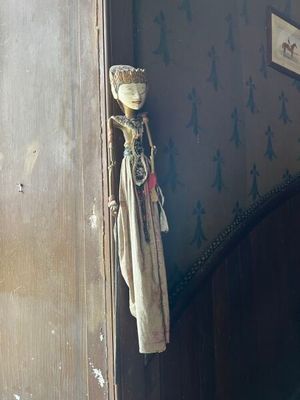 une petite poupée accrochée au mur