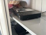 a white shelf with a dvd player on top of it