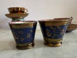 three cups and a saucer sitting on a table