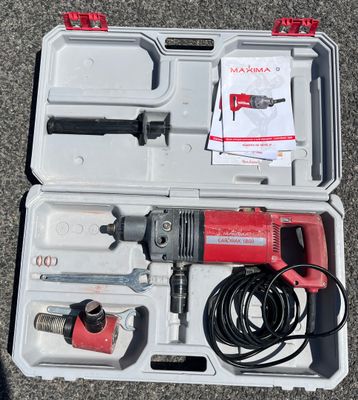 a box with a hammer, drill, and other tools in it