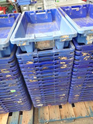 several blue plastic containers stacked on top of each other on a pallet