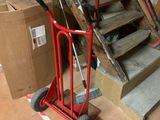 a hand truck that is sitting in front of some stairs