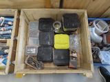 a wooden box filled with assorted items on the floor