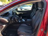 a red car with black seats in a parking lot