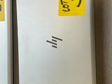 two white refrigerators on the wall with yellow stickers on them