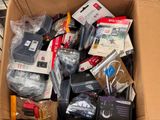 a cardboard box full of electronic devices and other items