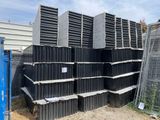 a pile of black steel bars stacked on top of each other