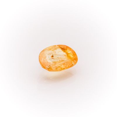 a close up of a yellow diamond on a white surface