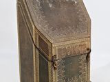 an old brown box with a metal handle on a white background