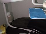 a dentist chair with a book on it in a room