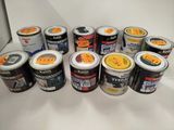 many cans of paint sitting on a white surface