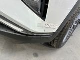the front bumper of a white car with a sticker on it ' s bumper