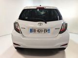 the back end of a white toyota yaris parked in a white room