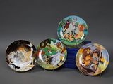 quatre assiettes disney sont empilées sur une table