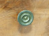 a small metal object on a wooden table
