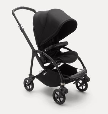 a black stroller with a black seat on a white background