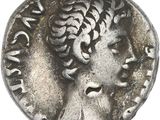 a close up of a coin with a woman ' s head on it