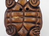 an image of a wooden turtle with its head on the back of it ' s shell