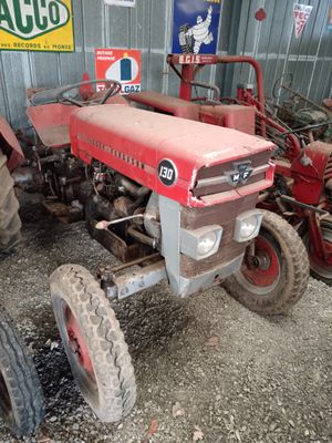 a red tractor that is parked in a garage