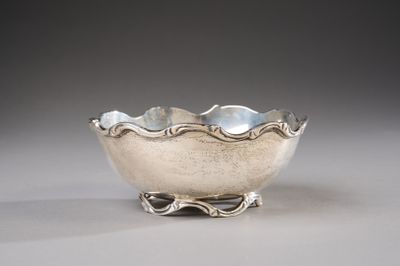 silver plated bowl on stand on grey background with light gray background