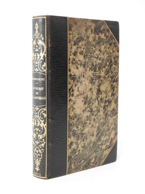 an old book with a gold and black cover on a white background