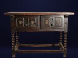 an old wooden table with two drawers on top of it