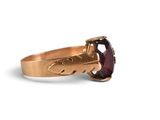 a close up of a gold ring with a garnetite stone