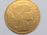 a close up of a gold coin on a white surface