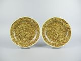 a pair of yellow and white plates on a white background